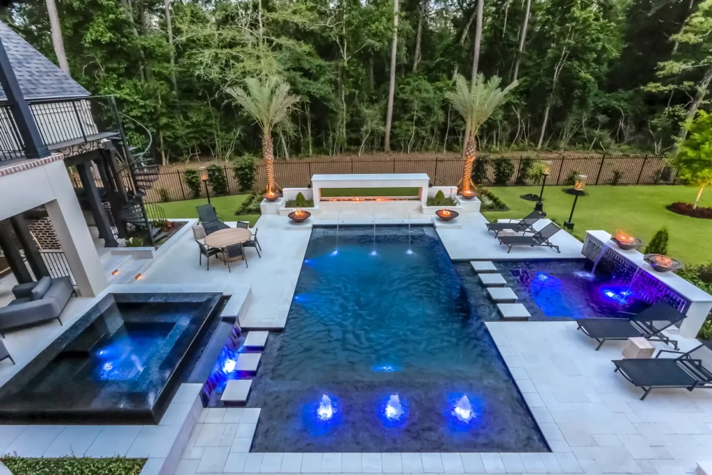 Luxurious concrete swimming pool in The Woodlands Texas area. Texas luxury backyard at dusk.