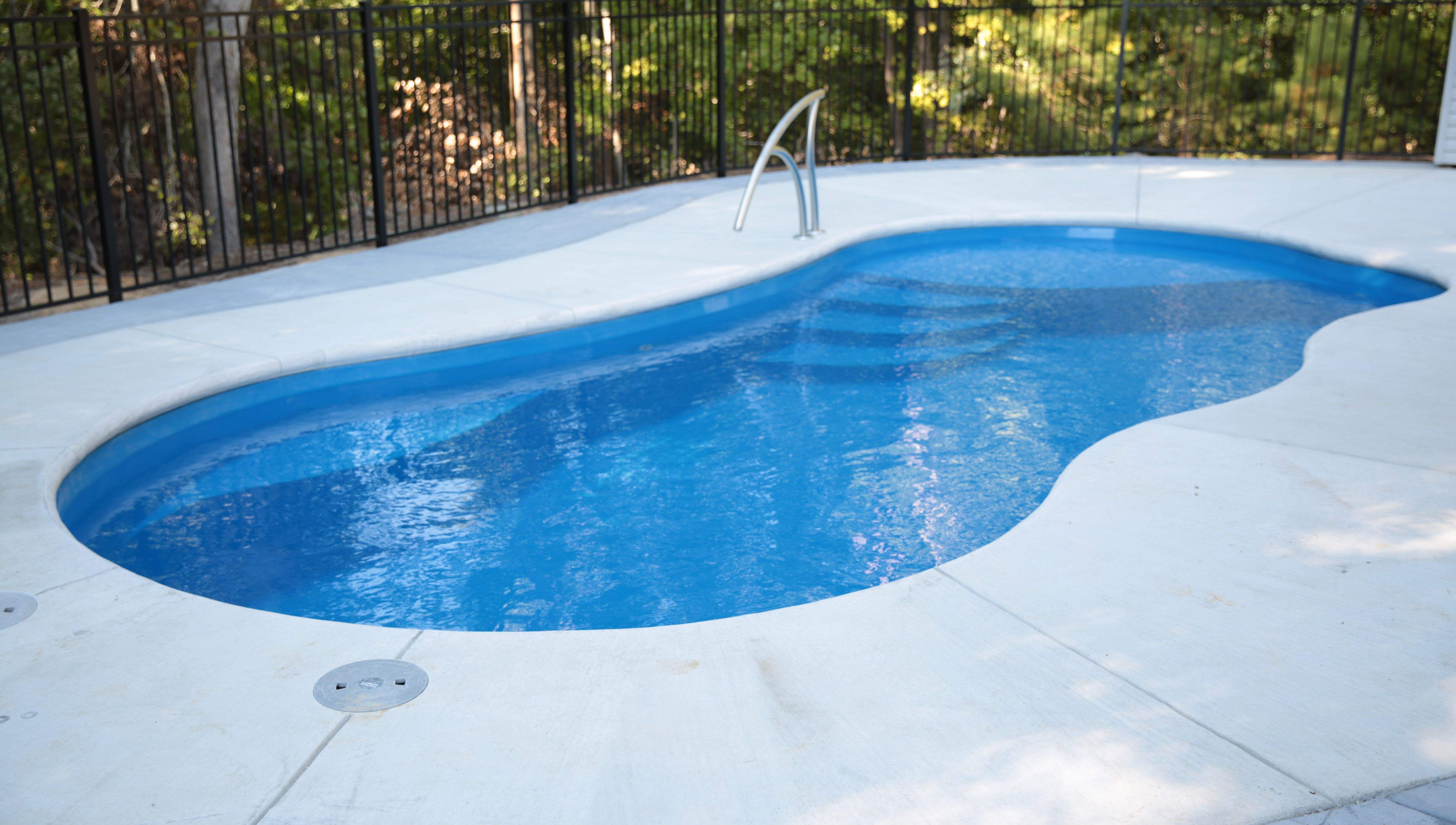 Modern fiberglass swimming pool in a Spring, Texas backyard.